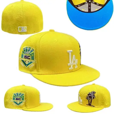 Five yellow fitted baseball caps shown from different angles, each with an embroidered front patch